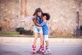 Two happy kids boy and girl roller skate in the park. Children and activity concept Royalty Free Stock Photo