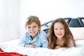 Two happy kids in pajamas celebrating pajama party. Preschool and school boy and girl having fun together. Children Royalty Free Stock Photo