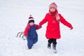 Two happy kids with sled walking on snow Royalty Free Stock Photo