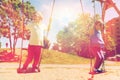 Two happy kids swinging on swing at playground Royalty Free Stock Photo