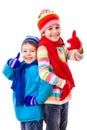 Two happy kids in winter clothes with thumbs up sign Royalty Free Stock Photo