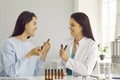 Woman consulting doctor to choose the right essential oils for aromatherapy purposes Royalty Free Stock Photo