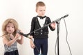 Two Happy little boys in smart clothes sing a song with a microphone at home. Preparing for the Christmas Karaoke Royalty Free Stock Photo