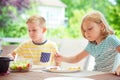 Two happy little children eating healthy breakfast at home Royalty Free Stock Photo