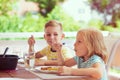 Two happy little children eating healthy breakfast at home Royalty Free Stock Photo