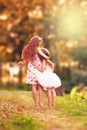 Two Happy little girl embracing and smiling at summer day, back Royalty Free Stock Photo