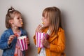 two happy little girls eating sweet popcorn Royalty Free Stock Photo