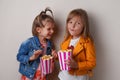 two happy little girls eating sweet popcorn Royalty Free Stock Photo