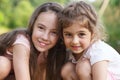 Two Happy little girls hugging at the summer park Royalty Free Stock Photo