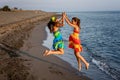 Two happy little girls jumping in the air on the beach Royalty Free Stock Photo