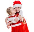 Two happy little girls in santa suits embracing Royalty Free Stock Photo