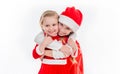 Two happy little girls in santa suits embracing Royalty Free Stock Photo