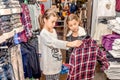 Two happy little girls shopping in retail store