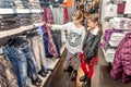 Two happy little girls shopping in retail store