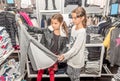 Two happy little girls shopping in retail store