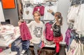 Two happy little girls shopping in retail store