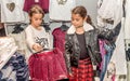 Two happy little girls shopping in retail store