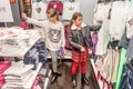 Two happy little girls shopping in retail store