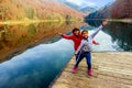 Two happy little girls standing on the pier of Lake Biograd (Bi