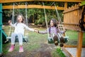 Two happy little girls swinging on the swing Royalty Free Stock Photo