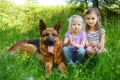 Two happy little girls and their big dog Royalty Free Stock Photo