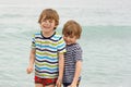 Two happy little kids boys running on the beach of ocean. Funny children, siblings, twins and best friends making Royalty Free Stock Photo