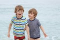 Two happy little kids boys running on the beach of ocean Royalty Free Stock Photo