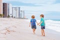 Two happy little kids boys running on the beach of ocean. Funny cute children, sibling and best friends making vacations Royalty Free Stock Photo