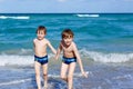 Two kid boys running on ocean beach. Little children having fun Royalty Free Stock Photo