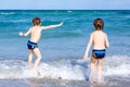 Two kid boys running on ocean beach. Little children having fun Royalty Free Stock Photo