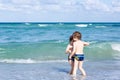 Two kid boys running on ocean beach. Little children having fun Royalty Free Stock Photo