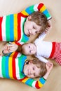 Two happy little preschool kids boys with newborn baby girl, cute sister. Siblings, twins children and baby playing Royalty Free Stock Photo