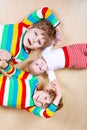 Two happy little preschool kids boys with newborn baby girl, cute sister. Siblings, twins children and baby playing Royalty Free Stock Photo