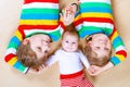 Two happy little preschool kids boys with newborn baby girl, cute sister. Siblings, twins children and baby playing Royalty Free Stock Photo