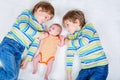 Two happy little preschool kids boys with newborn baby girl Royalty Free Stock Photo