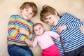 Two happy little preschool kids boys with newborn baby girl Royalty Free Stock Photo