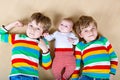 Two happy little preschool kids boys with newborn baby girl Royalty Free Stock Photo