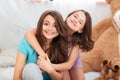 Two happy lovely sisters sitting and hugging at home Royalty Free Stock Photo