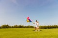 Two happy lovers with balloons having date in the park Royalty Free Stock Photo