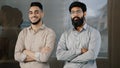 Two happy male colleagues multiracial diverse businesspeople partners men hispanic man arabian bearded guy smiling Royalty Free Stock Photo