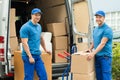 Worker With Cardboard Boxes In Front Of Truck Royalty Free Stock Photo