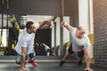 Two happy men fitness workout together at gym