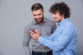 Two happy men using smartphone Royalty Free Stock Photo