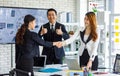 Two happy millennial professional successful businesswomen in formal suit standing shaking hands greeting together when business Royalty Free Stock Photo