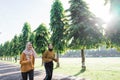 two happy Muslim girls in headscarves do outdoor sports while jogging together