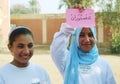 Two Happy Muslim girls holding arabic word Royalty Free Stock Photo