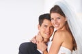 Two happy newlyweds. Portrait of a young couple embracing each other and smiling at the camera. Royalty Free Stock Photo
