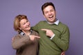 Two happy people woman and man mothr and son pointing fingers at each other Royalty Free Stock Photo