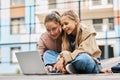 Two happy schoolgirls in casualwear looking at laptop screen Royalty Free Stock Photo