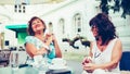 Two happy senior women laughing, talking and drinking coffee Royalty Free Stock Photo